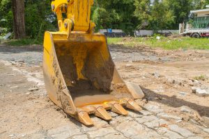 Backhoe digger loader vehicle at an outdoor site.